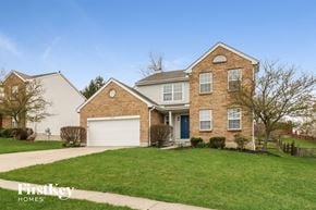 West Chester house for rent - a brick house with a green lawn and a white garage door