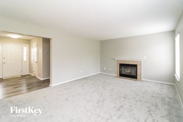 West Chester house for rent - a living room with a fireplace and a white carpet
