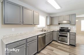 West Chester house for rent - a kitchen with stainless steel appliances and granite counter tops