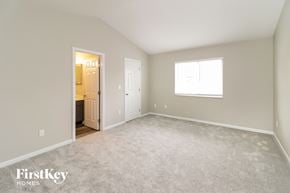 West Chester house for rent - a bedroom with a carpeted floor and a door to a bathroom