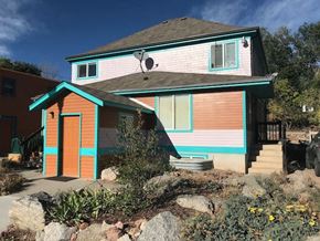 Colorado Springs apartment for rent - a pink and blue house with a porch