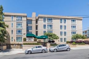 Oakland apartment for rent - A building with the sign "Lakepoint" is visible with two cars parked in front.
