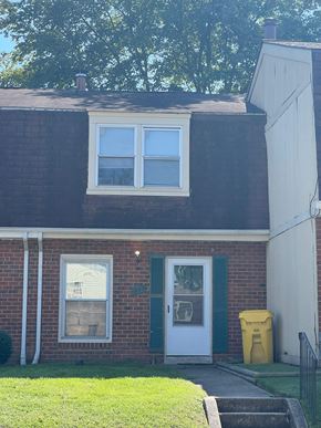 Severn house for rent - a brick house with a white door and window