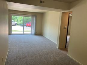Kentwood apartment for rent - an empty living room with a sliding glass door