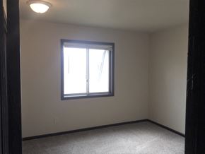 Kentwood apartment for rent - a bedroom with a window and a carpeted floor