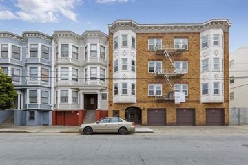San Francisco apartment for rent - a car parked in front of a building on a street