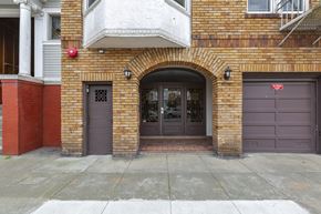 San Francisco apartment for rent - the front door of a brick building with two garage doors