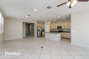 Tolleson house for rent - A spacious kitchen and living room with a ceiling fan and recessed lighting.