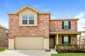 Fort Worth house for rent - a brick house with a garage door and a lawn