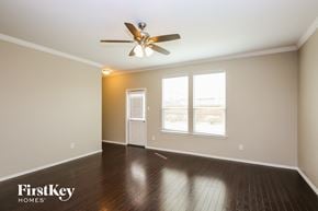 Fort Worth house for rent - a living room with hardwood floors and a ceiling fan