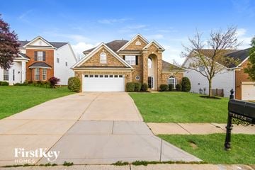 Charlotte house for rent - a house with a white garage door in front of a lawn