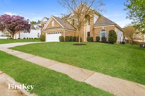 Charlotte house for rent - a home with a lawn and a sidewalk in front of it