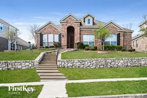 Garland house for rent - a home with a stone retaining wall and grass