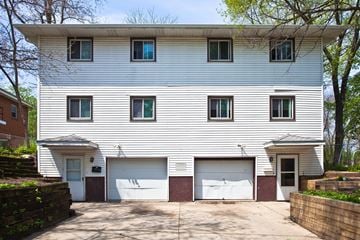 Madison apartment for rent - the front of a white house with two garage doors
