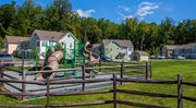 North East apartment for rent - a playground with slides and houses in the background