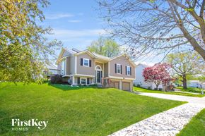 Kansas City house for rent - A house with a well-maintained lawn and a stone pathway leading to the front door.