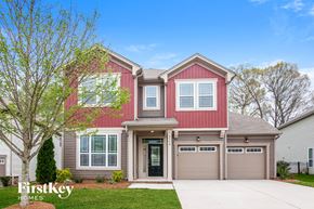 Concord house for rent - a renovated home with a red exterior and a gray garage door