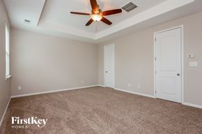 Concord house for rent - a bedroom with carpet and a ceiling fan