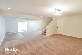 Morrow house for rent - A spacious room with a staircase and a window.