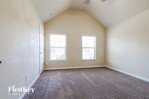 Braselton house for rent - a spacious living room with two windows and carpeting
