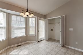 Holly Springs house for rent - A room with a tile floor and a chandelier.