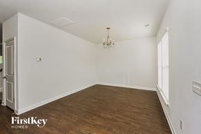 Moncks Corner house for rent - a living room with white walls and wood flooring and a chandelier