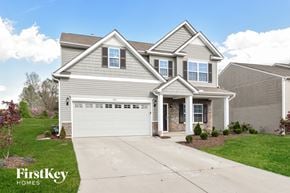 Whitsett house for rent - a suburban home with a white garage door