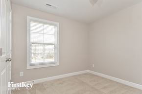 Whitsett house for rent - a bedroom with a window and a white door