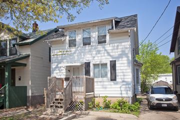 Madison apartment for rent - a white house with a car parked in front of it
