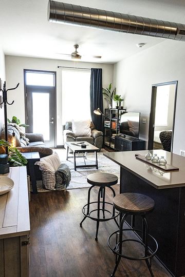 Waukee apartment for rent - a living room with a couch and a bar with stools