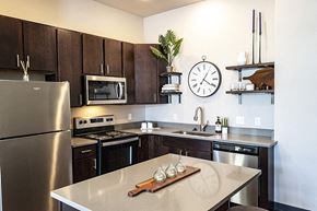 Waukee apartment for rent - a kitchen with stainless steel appliances and a clock on the wall