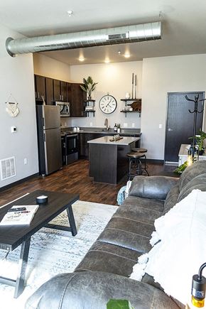 Waukee apartment for rent - a living room and a kitchen with a clock on the wall