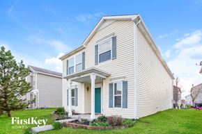 Noblesville house for rent - a white house with a blue door and a lawn