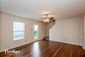 Noblesville house for rent - the living room and dining room with hardwood floors and a ceiling fan