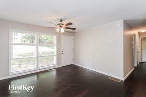 Kennesaw house for rent - a living room with a ceiling fan and a large window