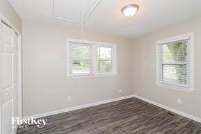 Kennesaw house for rent - a bedroom with a hard wood floor and two windows
