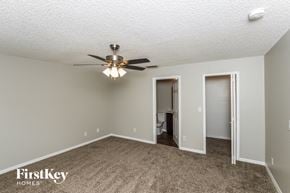 Palm Bay house for rent - a living room with a ceiling fan and a door to a bathroom