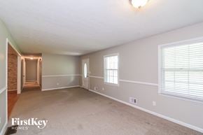 Kennesaw house for rent - a living room with a carpeted floor and a large window