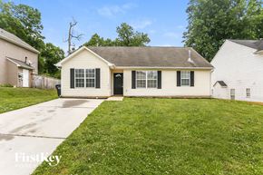 Charlotte house for rent - a white house with black shutters and a lawn