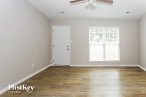 Charlotte house for rent - a living room with wood floors and a white door