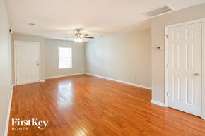 Summerville house for rent - A room with wooden floors and two white doors.