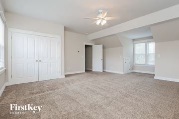Summerville house for rent - a spacious living room with carpet and a ceiling fan