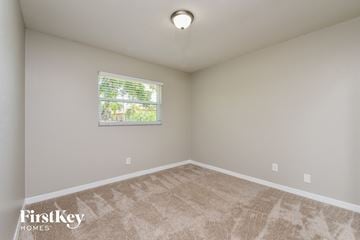 Cape Coral house for rent - a spacious living room with carpet and a window