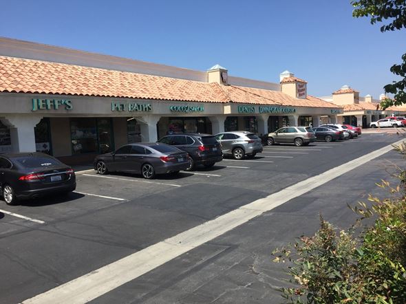San Jacinto apartment for rent - a parking lot in front of a shopping center with cars parked
