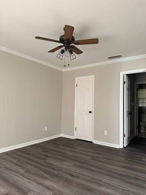 Albany apartment for rent - A room with a ceiling fan and a door.