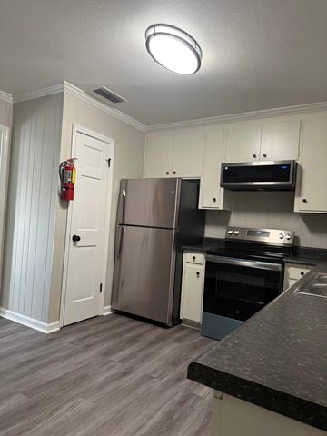 Albany apartment for rent - A kitchen with a stainless steel refrigerator and oven.