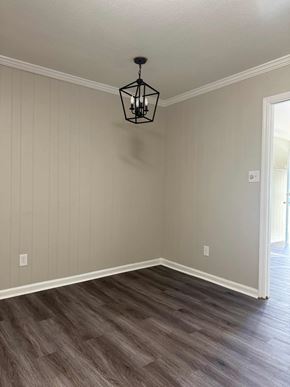 Albany apartment for rent - A room with a wooden floor and a hanging light fixture.