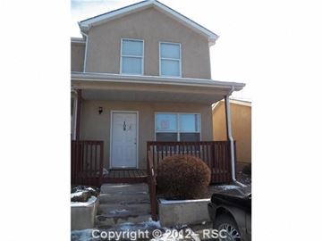 Pueblo house for rent - a house with a front porch and a white door