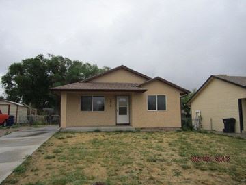 Pueblo house for rent - a beige house with a yard and a driveway