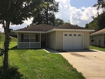 Tallahassee house for rent - A small house with a white fence in front.